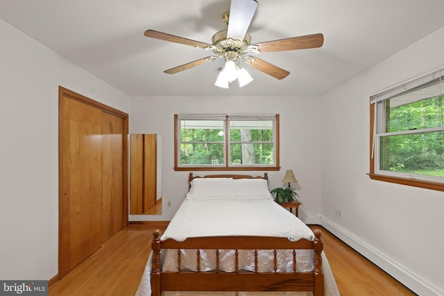 1906 Parkvue Rd, Fallston, MD 21047 - bedroom featuring baseboard heating, multiple windows, light wood-style floors, and ceiling fan