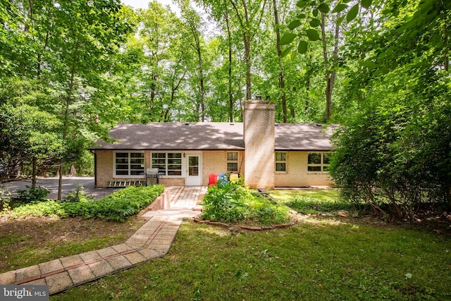 1906 Parkvue Rd, Fallston, MD 21047 - rear view of house featuring brick siding, a patio area, a yard, and a chimney