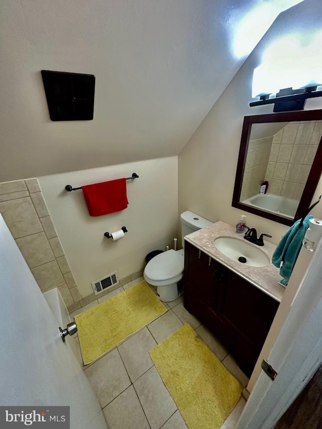 12403 Rambling Ln, Bowie, MD 20715 - full bath featuring tile patterned floors, toilet, vanity, and lofted ceiling