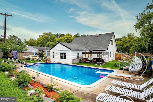 12403 Rambling Ln, Bowie, MD 20715 - view of pool with a patio, a diving board, and an outdoor structure