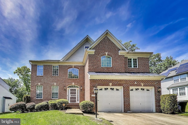 7009 Shagbark Ct, Fort Washington, MD 20744 - view of front of home featuring brick siding, a garage, concrete driveway, a standing seam roof, and metal roof