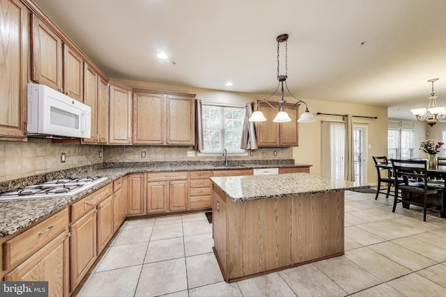 7009 Shagbark Ct, Fort Washington, MD 20744 - kitchen with white appliances, a sink, a chandelier, a kitchen island, and decorative backsplash