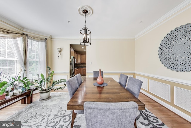 7009 Shagbark Ct, Fort Washington, MD 20744 - dining room featuring ornamental molding, light wood-style floors, and a wainscoted wall
