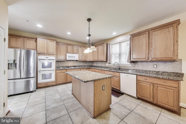 7009 Shagbark Ct, Fort Washington, MD 20744 - kitchen featuring white appliances, a sink, backsplash, a center island, and light stone counters