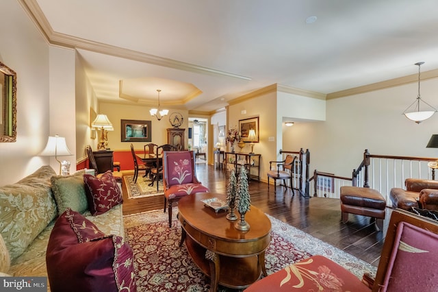 23412 Berkeley Meadows Dr, Ashburn, VA 20148 - living area featuring wood finished floors, ornamental molding, a chandelier, a tray ceiling, and baseboards
