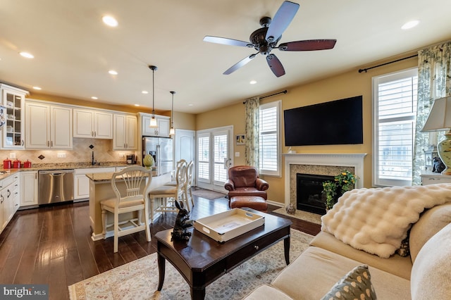 23412 Berkeley Meadows Dr, Ashburn, VA 20148 - living area with dark wood-style floors, ceiling fan, recessed lighting, and a premium fireplace