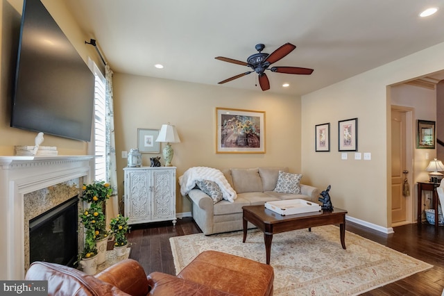 23412 Berkeley Meadows Dr, Ashburn, VA 20148 - living area with ceiling fan, recessed lighting, dark wood-style flooring, a fireplace, and baseboards