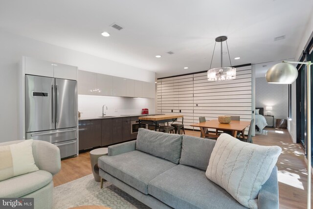57 N St NW Unit 134, Washington, DC 20001 - living area featuring light wood-style floors, a chandelier, and recessed lighting