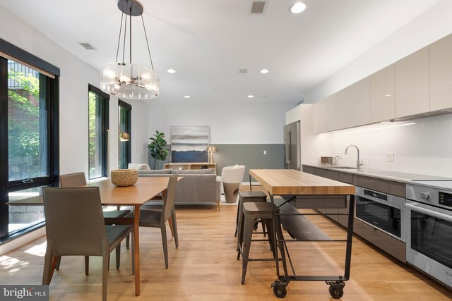 57 N St NW Unit 134, Washington, DC 20001 - dining room featuring recessed lighting, light wood finished floors, and a chandelier