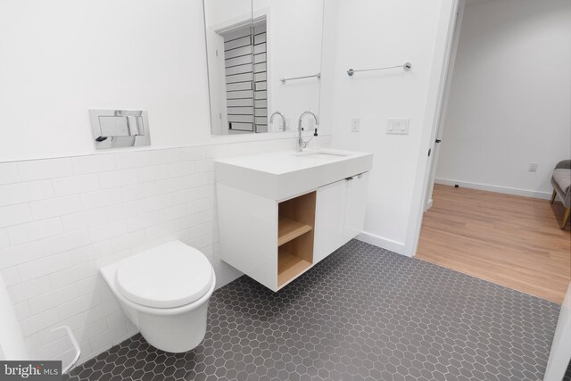 57 N St NW Unit 134, Washington, DC 20001 - bathroom with tile walls, toilet, vanity, and wainscoting