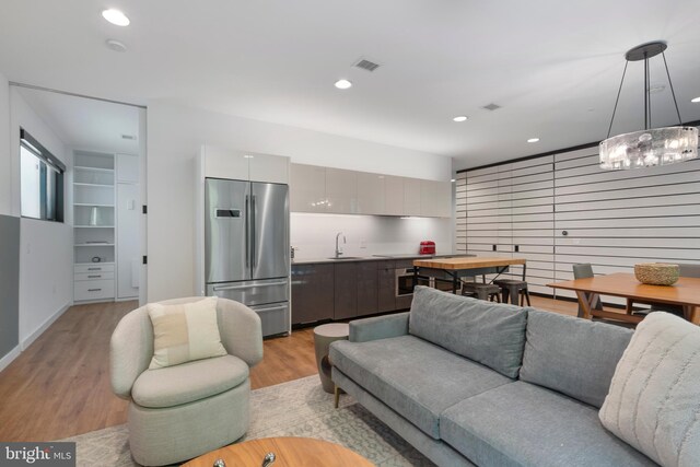 57 N St NW Unit 134, Washington, DC 20001 - living room with light wood-style flooring, recessed lighting, and a chandelier