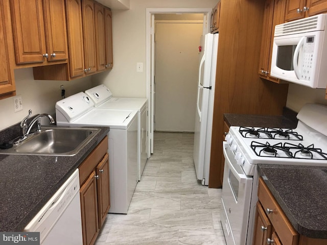 10241 Prince Pl Unit 27-T3, Upper Marlboro, MD 20774 - kitchen featuring white appliances, washer and dryer, a sink, brown cabinetry, and light marble finish floors