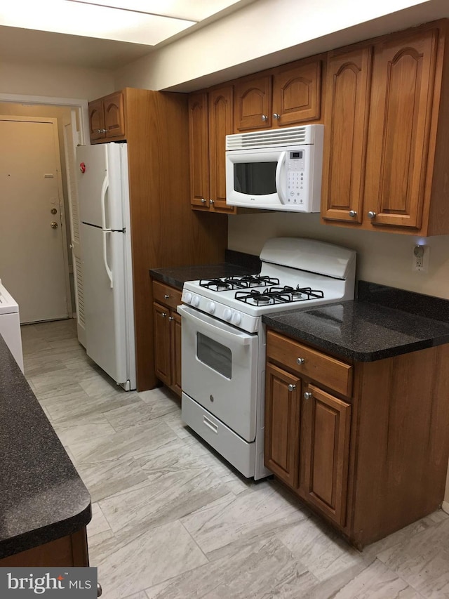10241 Prince Pl Unit 27-T3, Upper Marlboro, MD 20774 - kitchen with white appliances and brown cabinetry