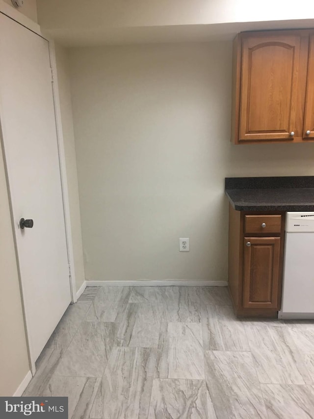 10241 Prince Pl Unit 27-T3, Upper Marlboro, MD 20774 - kitchen with dishwasher, dark countertops, baseboards, and brown cabinetry