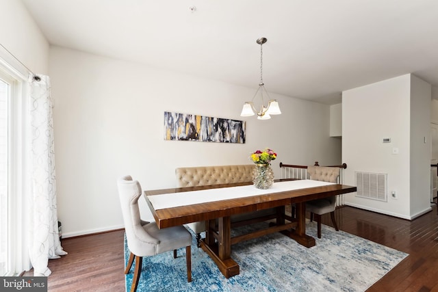 6315 Halsted Ave, Capitol Heights, MD 20743 - dining area with a chandelier, wood finished floors, and baseboards