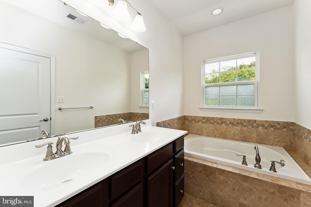 6315 Halsted Ave, Capitol Heights, MD 20743 - full bathroom with healthy amount of natural light, a garden tub, and double vanity