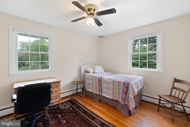 10 Old Orchard Ln, Chadds Ford, PA 19317 - bedroom with baseboard heating, wood finished floors, and multiple windows