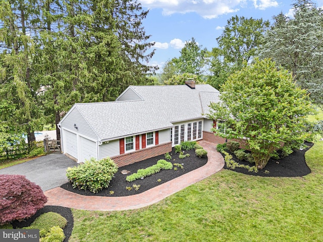 10 Old Orchard Ln, Chadds Ford, PA 19317 - view of front of house featuring driveway, a front lawn, a shingled roof, and a chimney
