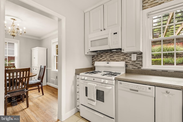 1861 S George Mason Dr, Arlington, VA 22204 - kitchen featuring white appliances, a chandelier, baseboards, plenty of natural light, and crown molding