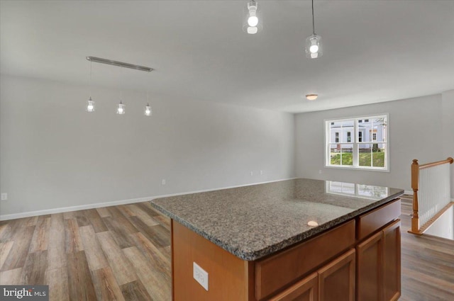 12366 Benning Ave, Waynesboro, PA 17268 - kitchen with wood finished floors, brown cabinets, open floor plan, a kitchen island, and decorative light fixtures