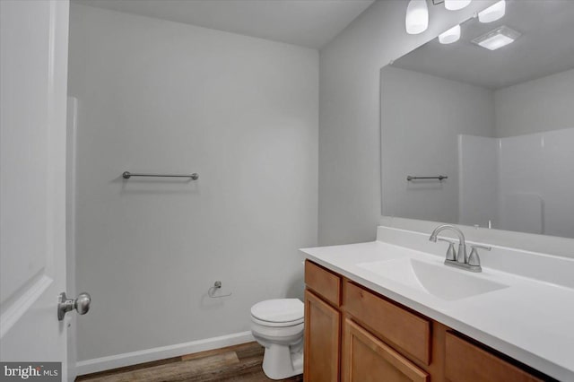 12366 Benning Ave, Waynesboro, PA 17268 - bathroom featuring vanity, wood finished floors, toilet, baseboards, and a shower