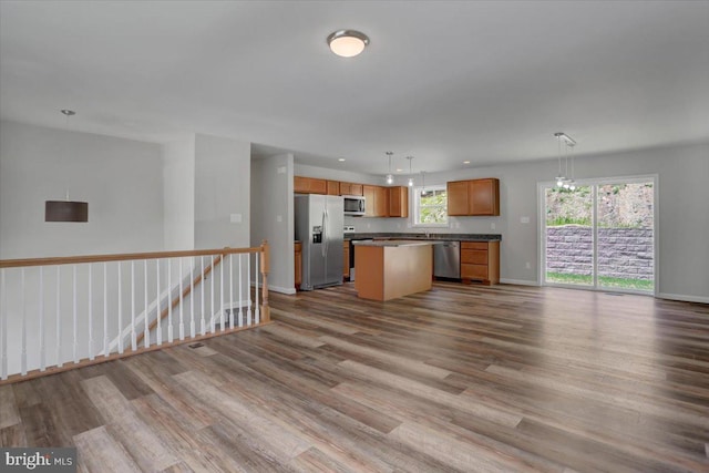 12366 Benning Ave, Waynesboro, PA 17268 - kitchen featuring stainless steel appliances, open floor plan, wood finished floors, a center island, and dark countertops