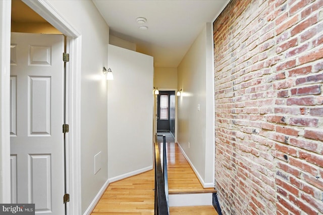 1225 W Cross St, Baltimore, MD 21230 - corridor with wood finished floors, brick wall, and baseboards