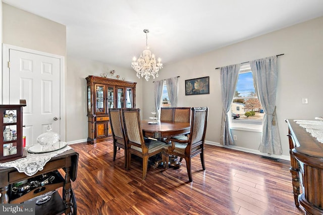 128 E Delaware Dr, Little Egg Harbor Twp, NJ 08087 - dining space featuring a chandelier, dark wood-type flooring, and baseboards