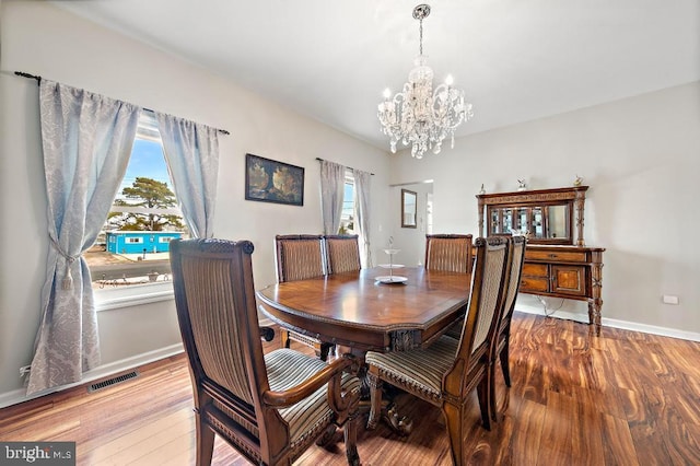 128 E Delaware Dr, Little Egg Harbor Twp, NJ 08087 - dining space with a chandelier, wood finished floors, and baseboards