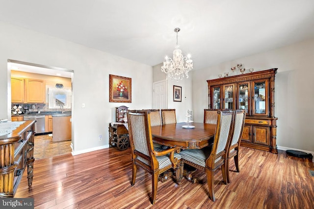 128 E Delaware Dr, Little Egg Harbor Twp, NJ 08087 - dining area featuring a chandelier, light wood-style flooring, and baseboards