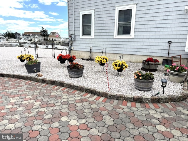 128 E Delaware Dr, Little Egg Harbor Twp, NJ 08087 - view of side of property with a gate and a patio
