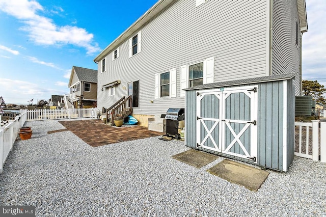 128 E Delaware Dr, Little Egg Harbor Twp, NJ 08087 - back of house with a fenced backyard, entry steps, a patio area, and board and batten siding
