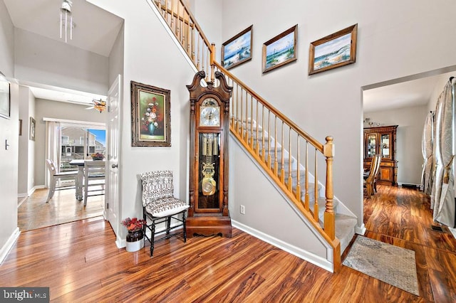 128 E Delaware Dr, Little Egg Harbor Twp, NJ 08087 - staircase with wood finished floors, baseboards, a towering ceiling, and a ceiling fan