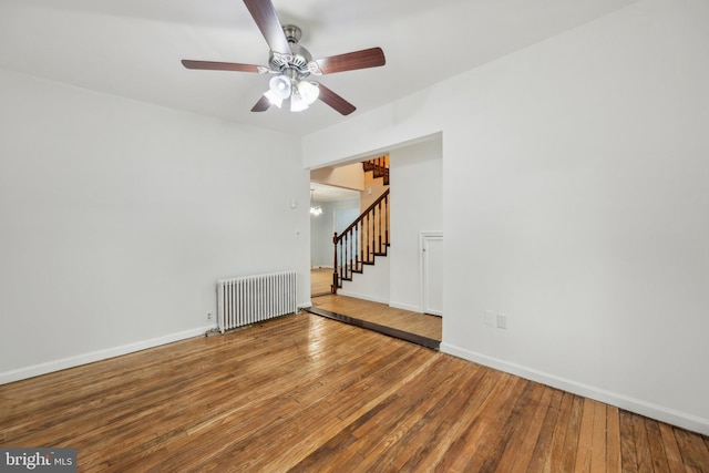 4311 Quinn St, Capitol Heights, MD 20743 - unfurnished room featuring radiator heating unit, stairway, ceiling fan, hardwood / wood-style floors, and baseboards