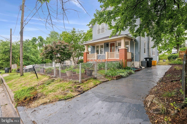 4311 Quinn St, Capitol Heights, MD 20743 - view of front of home featuring covered porch, a fenced front yard, a gate, driveway, and brick siding