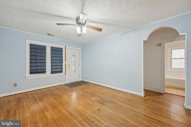 4311 Quinn St, Capitol Heights, MD 20743 - unfurnished room featuring arched walkways, ornamental molding, plenty of natural light, wood-type flooring, and a ceiling fan