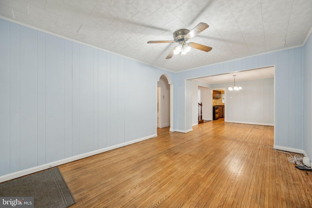 4311 Quinn St, Capitol Heights, MD 20743 - unfurnished living room featuring wood-type flooring, ceiling fan, arched walkways, ornamental molding, and a chandelier