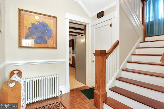 604 Market St, Pocomoke City, MD 21851 - staircase featuring radiator heating unit, ornamental molding, and lofted ceiling