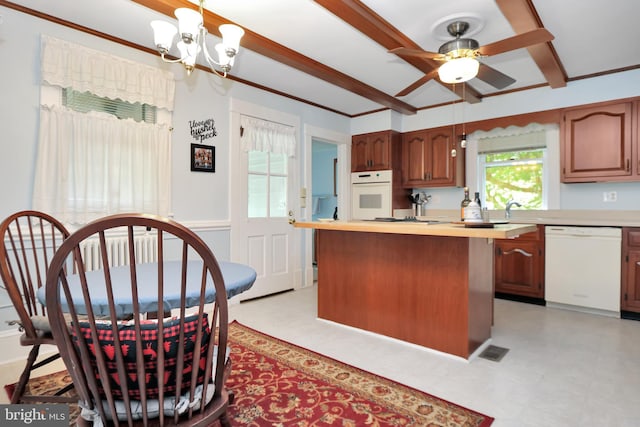 604 Market St, Pocomoke City, MD 21851 - kitchen featuring white appliances, a chandelier, ceiling fan, beamed ceiling, and a kitchen island