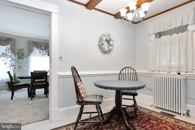 604 Market St, Pocomoke City, MD 21851 - dining space featuring radiator, a chandelier, carpet flooring, and crown molding