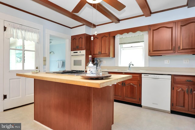 604 Market St, Pocomoke City, MD 21851 - kitchen with white appliances, a sink, beamed ceiling, a ceiling fan, and light floors