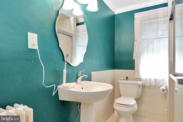 604 Market St, Pocomoke City, MD 21851 - half bathroom featuring toilet, ornamental molding, tile walls, a wainscoted wall, and tile patterned floors