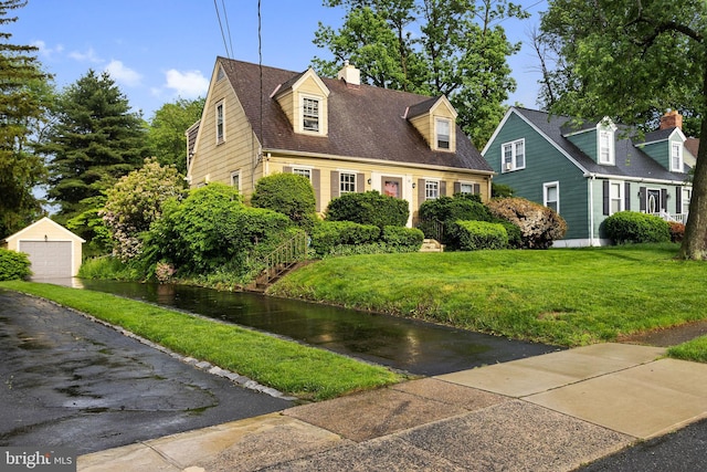 10 Pershing Ave, Ewing, NJ 08618 - cape cod home with a detached garage, a chimney, an outbuilding, and a front lawn