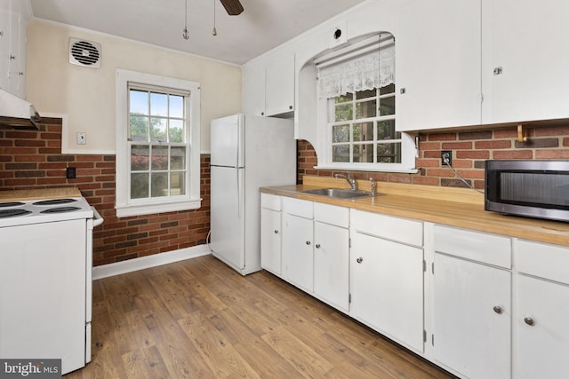 10 Pershing Ave, Ewing, NJ 08618 - kitchen featuring a sink, white appliances, white cabinetry, crown molding, and brick wall