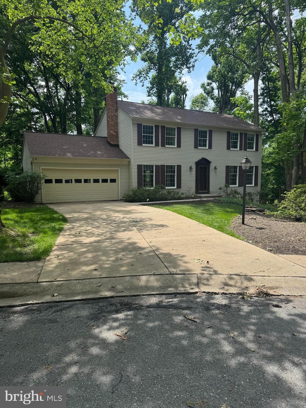 6193 Commadore Ct, Columbia, MD 21045 - colonial inspired home with a garage, concrete driveway, and a chimney