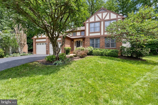9300 Olivia Pl, Burke, VA 22015 - tudor house with driveway, a front lawn, brick siding, and a garage