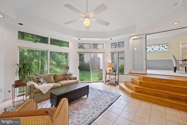 9300 Olivia Pl, Burke, VA 22015 - living room featuring light tile patterned floors, healthy amount of natural light, a ceiling fan, recessed lighting, and a tray ceiling