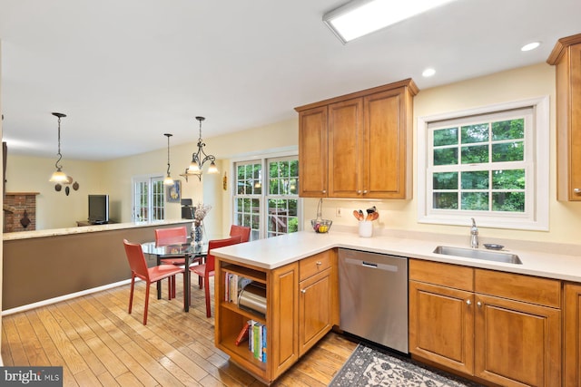 9300 Olivia Pl, Burke, VA 22015 - kitchen with stainless steel dishwasher, a sink, a peninsula, light wood finished floors, and brown cabinetry