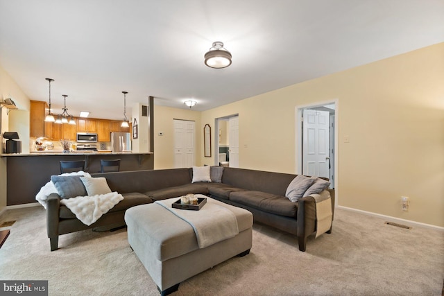 9300 Olivia Pl, Burke, VA 22015 - living room with light carpet, baseboards, and a chandelier