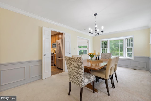9300 Olivia Pl, Burke, VA 22015 - dining space with a chandelier, crown molding, a wainscoted wall, light colored carpet, and a decorative wall